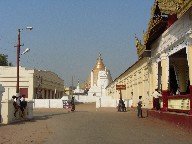 At the end of the street a stupa is visible